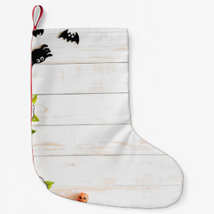 Halloween pumpkins, bats, spider top view. small christmas stocking