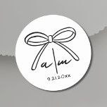 Hand Drawn Bow Whimsical Wedding Monogram Classic Round Sticker<br><div class="desc">Hand Drawn Bow Whimsical Wedding Monogram Classic Round Sticker. Minimalist Round Wedding Stickers. These cute and simple round wedding stickers are the perfect touch for sealing envelopes, decorating favours, or adding a personalised element to your wedding details. At the centre, a hand-drawn bow is paired with the bride and groom's...</div>
