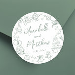 Hand Drawn Green Whimsical Wedding Classic Round Sticker<br><div class="desc">Personalised Hand-Drawn Quirky Sage Green Wedding Stickers. These fun and playful round wedding stickers feature quirky doodle illustrations surrounding the edges, all in a soft sage green theme. Elements like a champagne tower, wedding cake, disco ball, hearts, wedding bells, rings, cameras, and more create a whimsical and celebratory vibe. The...</div>