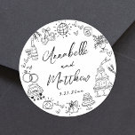 Hand Drawn Quirky Whimsical Wedding Classic Round Sticker<br><div class="desc">Personalised Hand-Drawn Quirky Black and White Wedding Stickers. These fun and playful round wedding stickers feature quirky doodle illustrations surrounding the edges, all in bold black against a crisp white background. Elements like a champagne tower, wedding cake, disco ball, hearts, wedding bells, rings, cameras, and more create a whimsical and...</div>