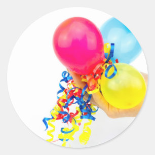 Hand giving colourful balloons with ribbons classic round sticker