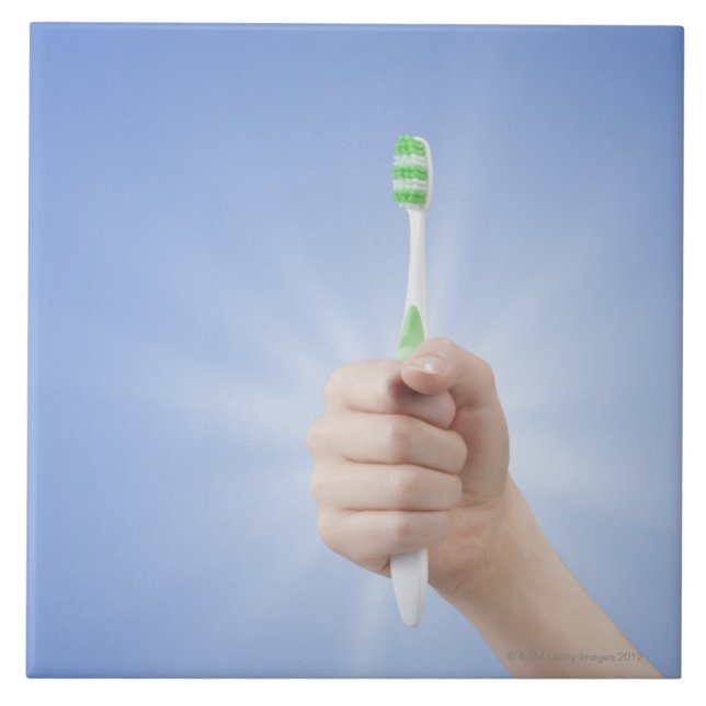 Hand holding tooth brush tile (Front)