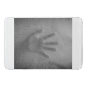 hand in the shower bath mat