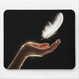 Hand Releasing a White Feather Mouse Mat