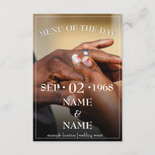 Hands of a coloured wedding couple pin on ring enclosure card