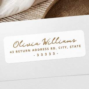 Handwritten script white return address label