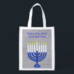 Hanukkah Dark Blue Menorah Silver Minimalist Reusable Grocery Bag<br><div class="desc">This festive Happy Hanukkah reusable tote can be used as a jumbo gift bag for an extra large present or take it to the mall. The navy blue and white Menorah with a Star Of David design on the base is showcased on a background of faux silver cloth. Click on...</div>