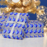 Hanukkah Dreidels Blue Pattern Personalise This Wrapping Paper<br><div class="desc">Dancing Dreidels in blue form a cheerful pattern on this Hanukkah wrapping paper perfect for kids or adults. Unwrap eight nights of Chanukah fun with bold colours of blue, white and silver with two spaces for your own text, which can also be deleted for Dreidel only gift wrap. Personalise each...</div>