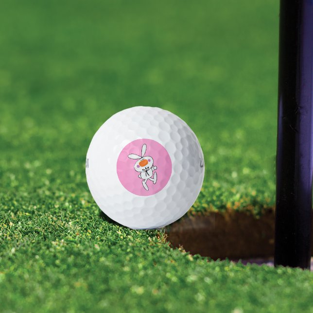 Happy Dancing Cute Cartoon White Rabbit Bunny Golf Balls (Cute white bunny thumbs up sign orange nose on pink background on golf balls.)