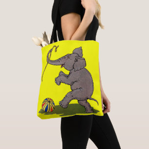 happy elephant playing with rope and ball tote bag
