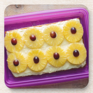 Hawaii slices with pineapple on rustic wood coaster