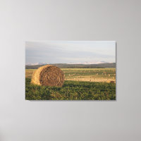 Hay Bales In A Field With Mountains At Sunrise