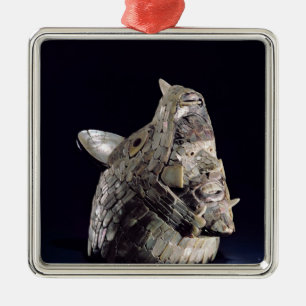Head of an animal with human head in open jaws metal tree decoration
