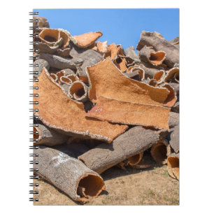 Heap of cork tree bark as raw material.JPG Notebook