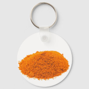 Heap of spice cayenne pepper powder on white key ring