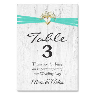 Heart with Turquoise Ribbon On Whitewashed Wood Table Number