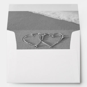 Hearts in the beach sand lined wedding envelopes