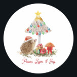 Hedgehog Mushrooms Woodland Christmas Classic Round Sticker<br><div class="desc">Illustration of a hedgehog wearing a santa hat with mushrooms decorated with Christmas lights,  bow,  star,  and gifts.  Text says,  "Peace,  Love,  & Joy"</div>
