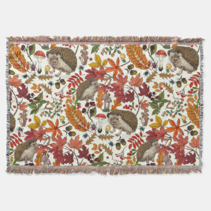 Hedgehogs and autumn forest flora on ivory throw blanket