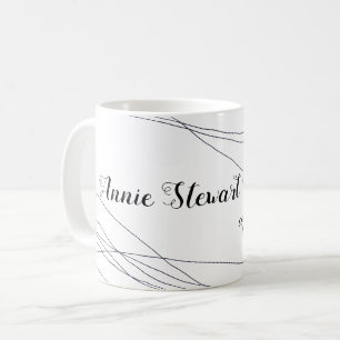 her name handwritten with thin curves on white coffee mug