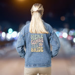 Here Comes The Bride Retro Bachelorette Party Denim Jacket<br><div class="desc">Cute bride's bachelorette party denim jacket featuring "Here Comes The Bride" in a large wavy retro font in shades of dusty sage green,  pink,  blue and yellow and an 70's style illustration of a flower. A coordinating "Here Comes The Party" jacket is available for the bach group.</div>