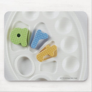 High angle view of alphabets on a palette mouse mat