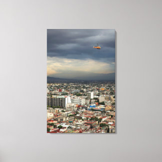 High Angle View Of Cityscape Against Cloudy Sky Canvas Print
