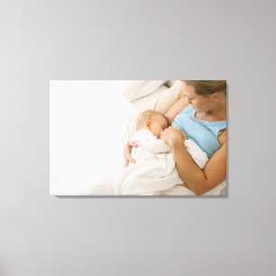 High angle view of woman breastfeeding baby canvas print