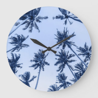 High palm trees, clear blue sky. large clock