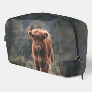 Highland cow calf autumn grass field dopp kit