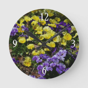 Hillside of Purple and Yellow Pansies Round Clock