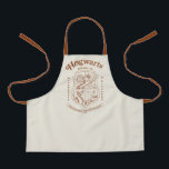 HOGWARTS™ School of Witchcraft and Wizardry Crest Apron<br><div class="desc">Honor the legacy of the wizarding world with this timeless Hogwarts™ School of Witchcraft & Wizardry crest design. Featuring the iconic four-house shield — lion, serpent, badger, and eagle — this elegant artwork represents the unity and tradition of Gryffindor™, Slytherin™, Hufflepuff™, and Ravenclaw™. Rendered in a refined, vintage-inspired line style,...</div>