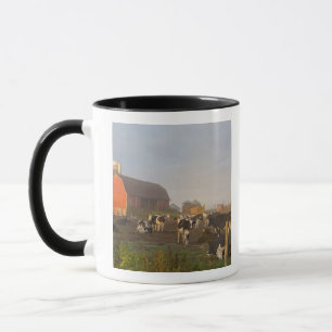 Holstein dairy cows outside a barn at sunrise mug