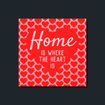 Home is Where The Heart Is Message Canvas Print<br><div class="desc">Home sweet home. An upbeat message that says "Home is Where The Heart Is". Red and Pink colour theme with a large heart as the main motif. More smaller hearts form a patterned background.</div>