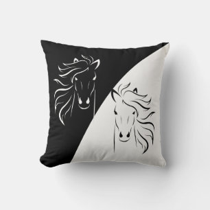 Horse silhouettes on abstract black and white cushion