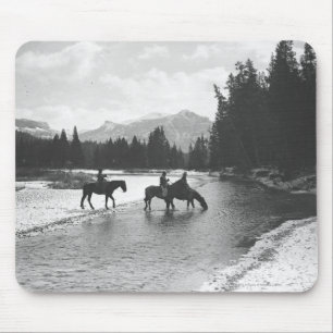 Horses drinking from and crossing a river mouse mat