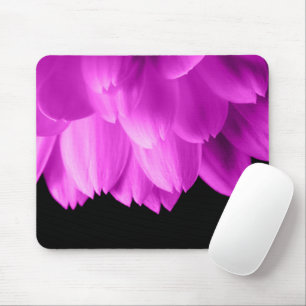 Hot pink flower petals on black mouse mat