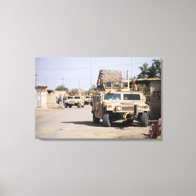 Humvee's conduct security during a patrol canvas print (Front)