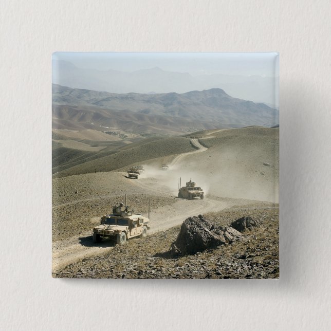Humvees traverse rugged mountain roads 15 cm square badge (Front)