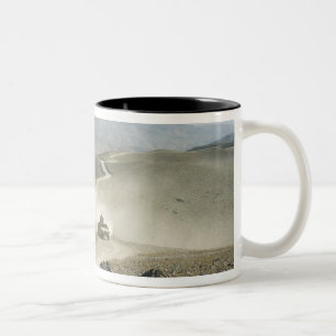 Humvees traverse rugged mountain roads Two-Tone coffee mug