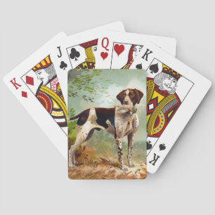 Hunter dog with bird in mouth playing cards