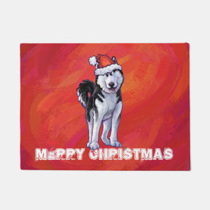 Husky in Santa Hat On Red Doormat