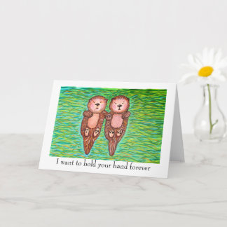 I love you card with two otters holding hands.