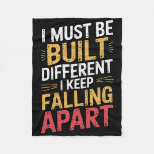 I Must Be Built Different I Keep Falling Apart Fleece Blanket