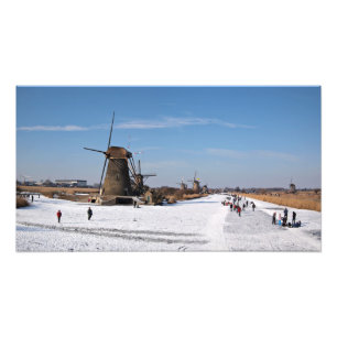 Ice skating along the windmills in winter photo print