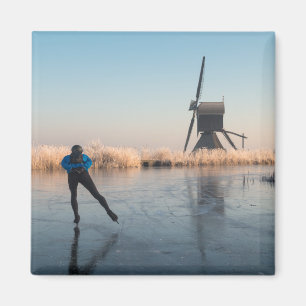 Ice skating past windmill and reeds magnet