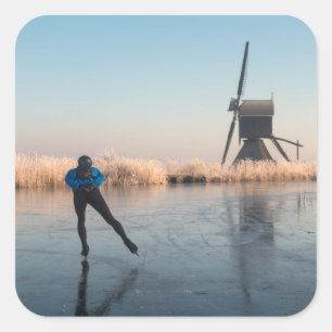 Ice skating past windmill and reeds sticker