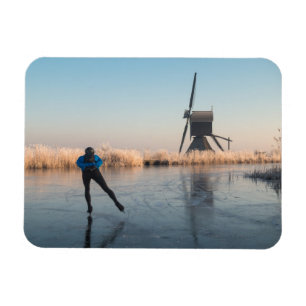 Ice skating past windmill & reeds rectangle magnet