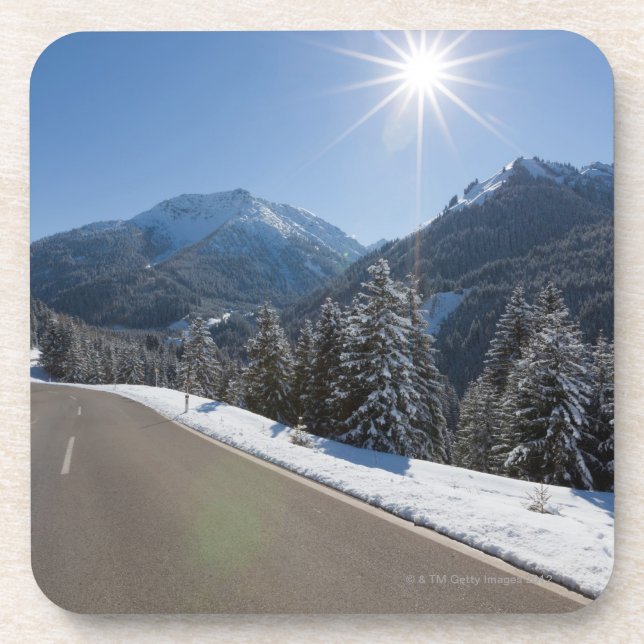 Idyllic empty road thrugh a winter landscape, 2 coaster (Front)