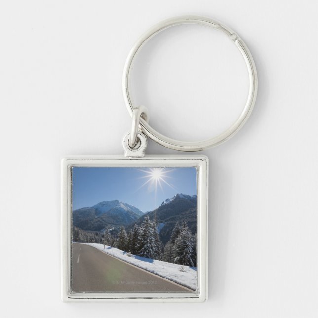 Idyllic empty road thrugh a winter landscape, 2 key ring (Front)